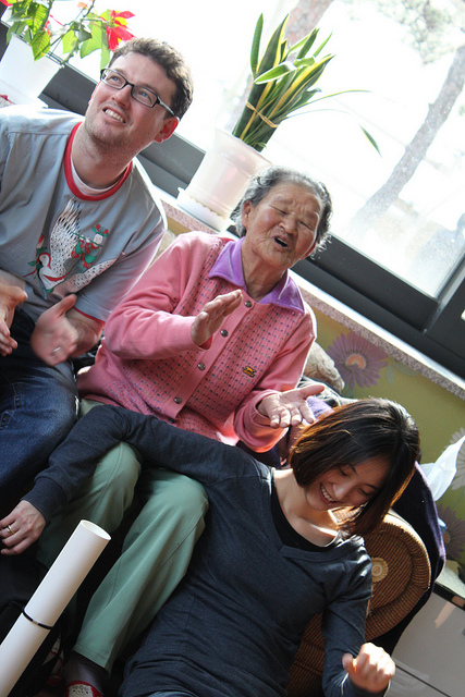 An elderly Korean woman, one of the comfort women, signing